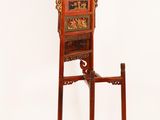 a tall wooden chair with carvings on the back of it