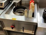 a stove with a pot on top of it in a kitchen