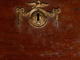 a close up of a wooden cabinet with a keyhole