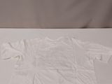 white t - shirt sitting on a white surface with a white background
