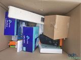 a cardboard box filled with electronics and other items