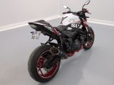 a white and red motorcycle parked in a room