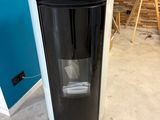 a black and white trash can in the corner of a room