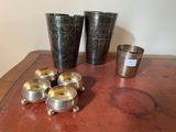 quatre tasses et un porte-tasse posés sur une table