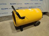 a yellow barrel sitting on top of a cement floor next to a sign