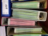 a lot of folders that are stacked up on the desk