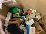 a cardboard box full of electronic devices and other items