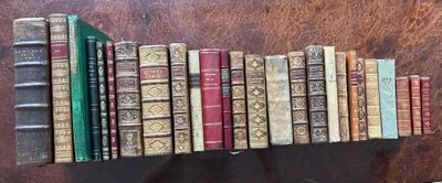 many books that are stacked on a shelf