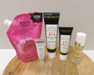 a wooden board with various skin care products on it
