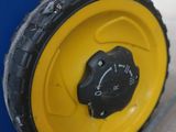 a close up of a yellow wheel on a blue cart