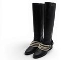 une paire de bottes en cuir noir ornées de perles et de chaînes
