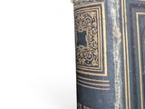 an old book sitting on top of a white table
