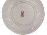 a white plate with a brown design on it