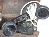 an old fashioned phone sitting in a box with a cord attached to it