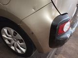a car that has been dented and is parked in a garage