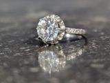 a close up photo of a diamond ring on a table