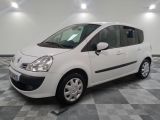 a picture of a small white car parked in a garage