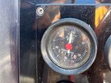 a close up of a clock on the side of a vehicle