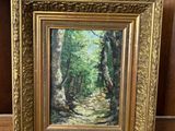 an oil painting of a path in the woods by a wooden easel