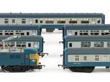 three blue and white trains sitting next to each other on a white surface
