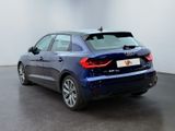 the rear end of a blue audi car in a white room
