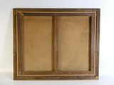 an old wooden frame with a window on a white wall