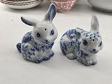 two blue and white rabbits sitting next to each other on a table