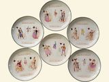 six porcelain plates with pictures of people on them sitting on a table