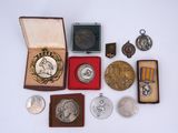 several medals and medals are displayed in a box on a white surface
