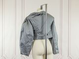 the back of a mannequin mannequin with a jacket on it