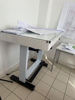 a white desk with a computer on it in a room