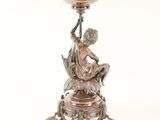 an image of a silver plate with a statue on it