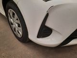 a close up of a white car in a garage
