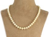 a white pearl necklace on a mannequin mannequin
