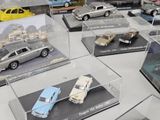 many different models of cars on display in a display case