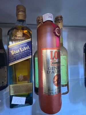 several bottles of liquor are on display in a glass case