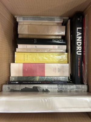 a box full of books that are stacked on top of each other