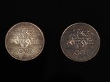 two silver coins with the olympic symbols on them