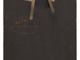an old photo of a piece of paper with a bow on it