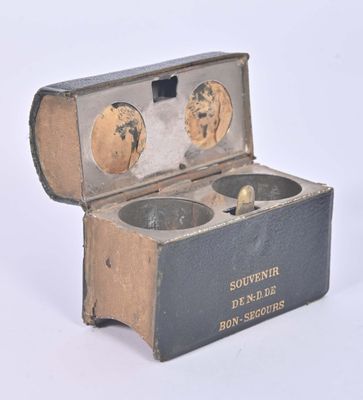 a box with two bowls inside of it on a white surface