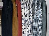 a lot of clothes hanging on a rack in a room