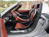 the interior of a silver sports car with red leather seats