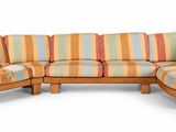 a couch and ottoman in a room with a white background