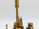 a yellow construction vehicle and a bulldozer next to each other