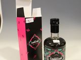a bottle of liquor next to a box of cigarettes