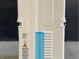 a white and blue refrigerator sitting on a pallet