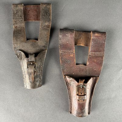 two pieces of wood and metal are sitting on a gray surface