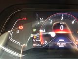 the dashboard of a car with a digital display on it