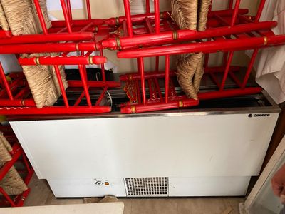 a picture of a room with a bunch of red pipes