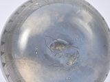 a silver object that is sitting on a white surface